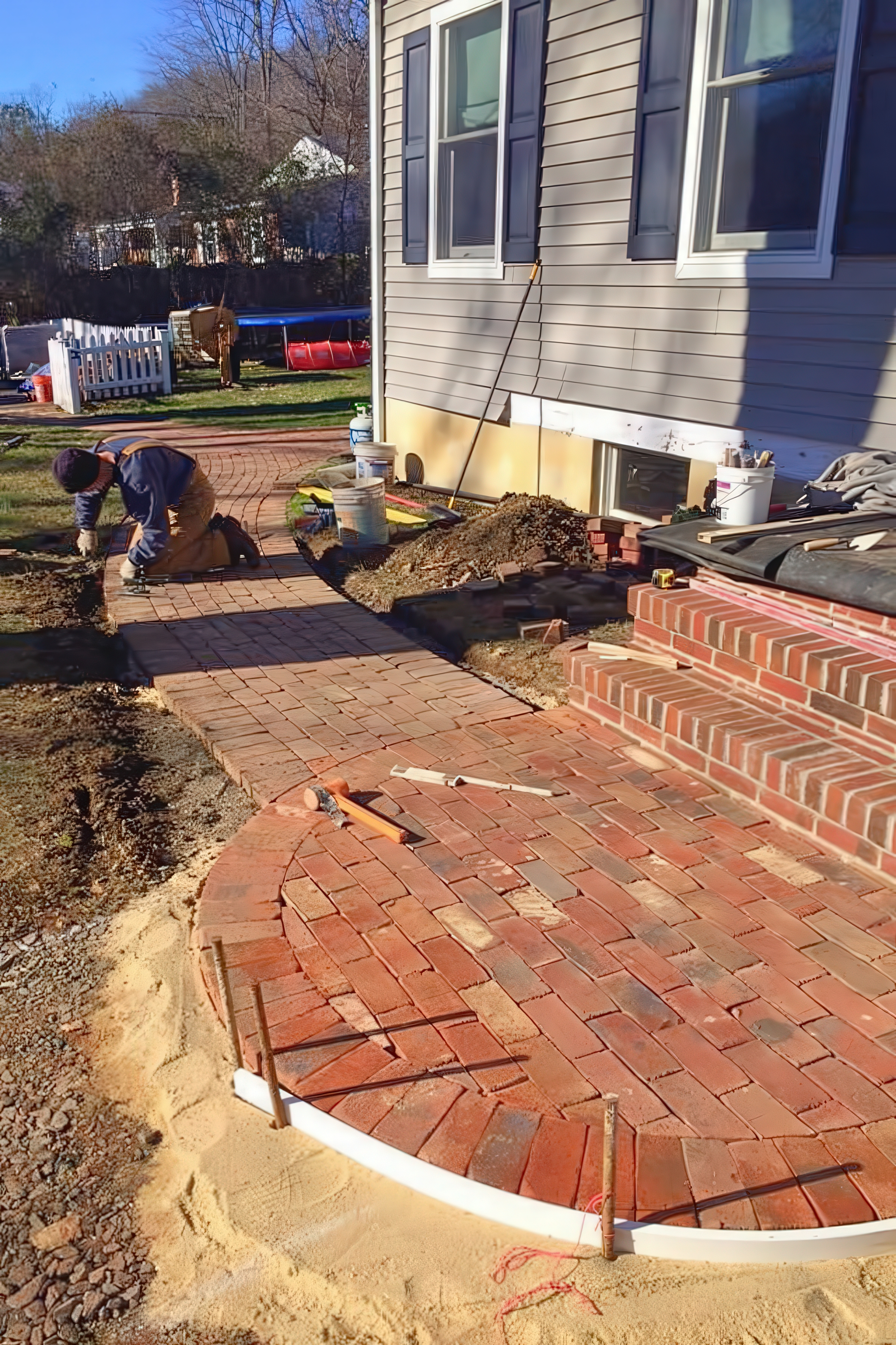 Scott laying brick on the curved walkway section, in progress