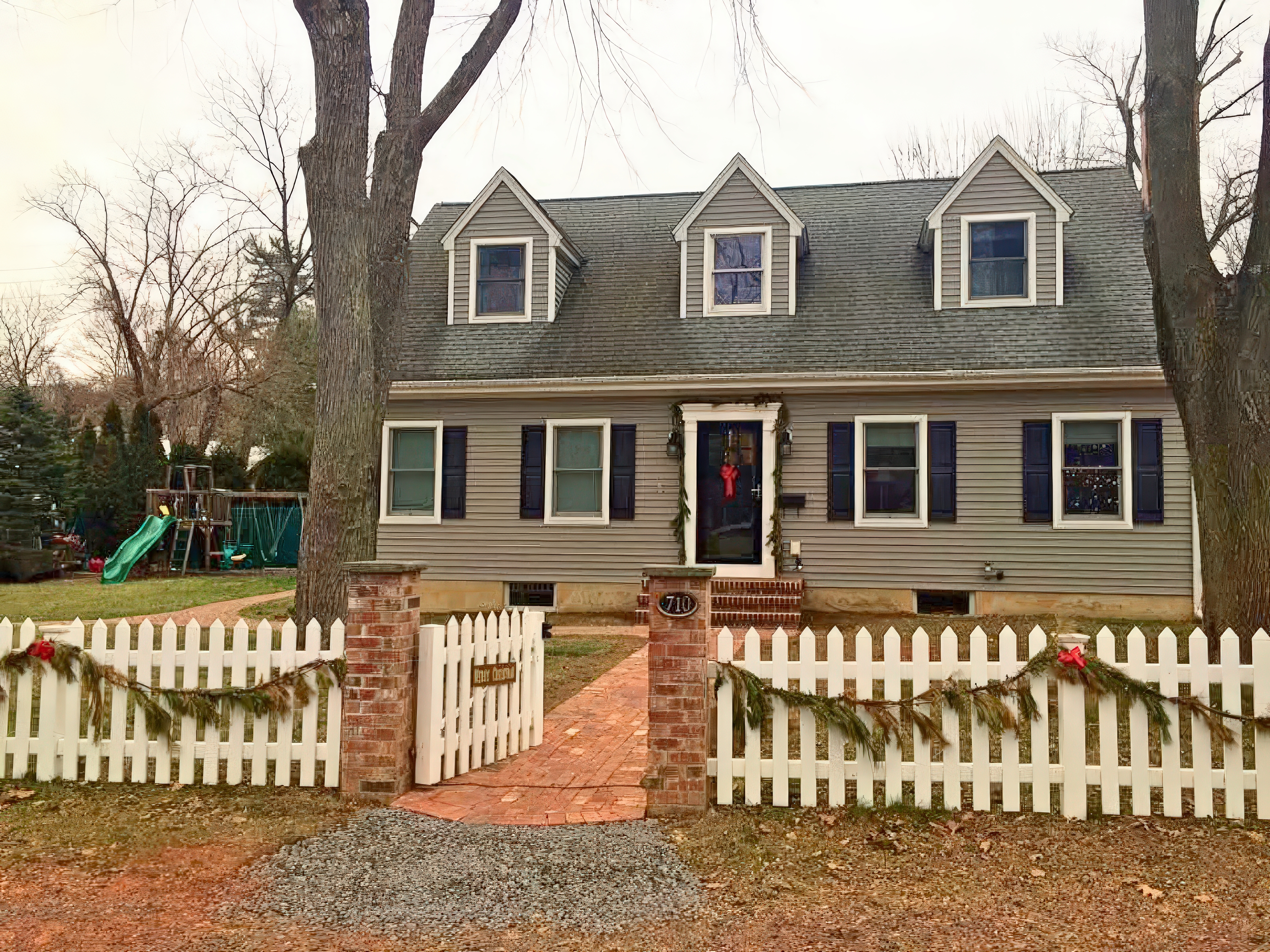 Completed brick walkway with herringbone pattern, brick pillars, and picket fence in Langhorne, PA