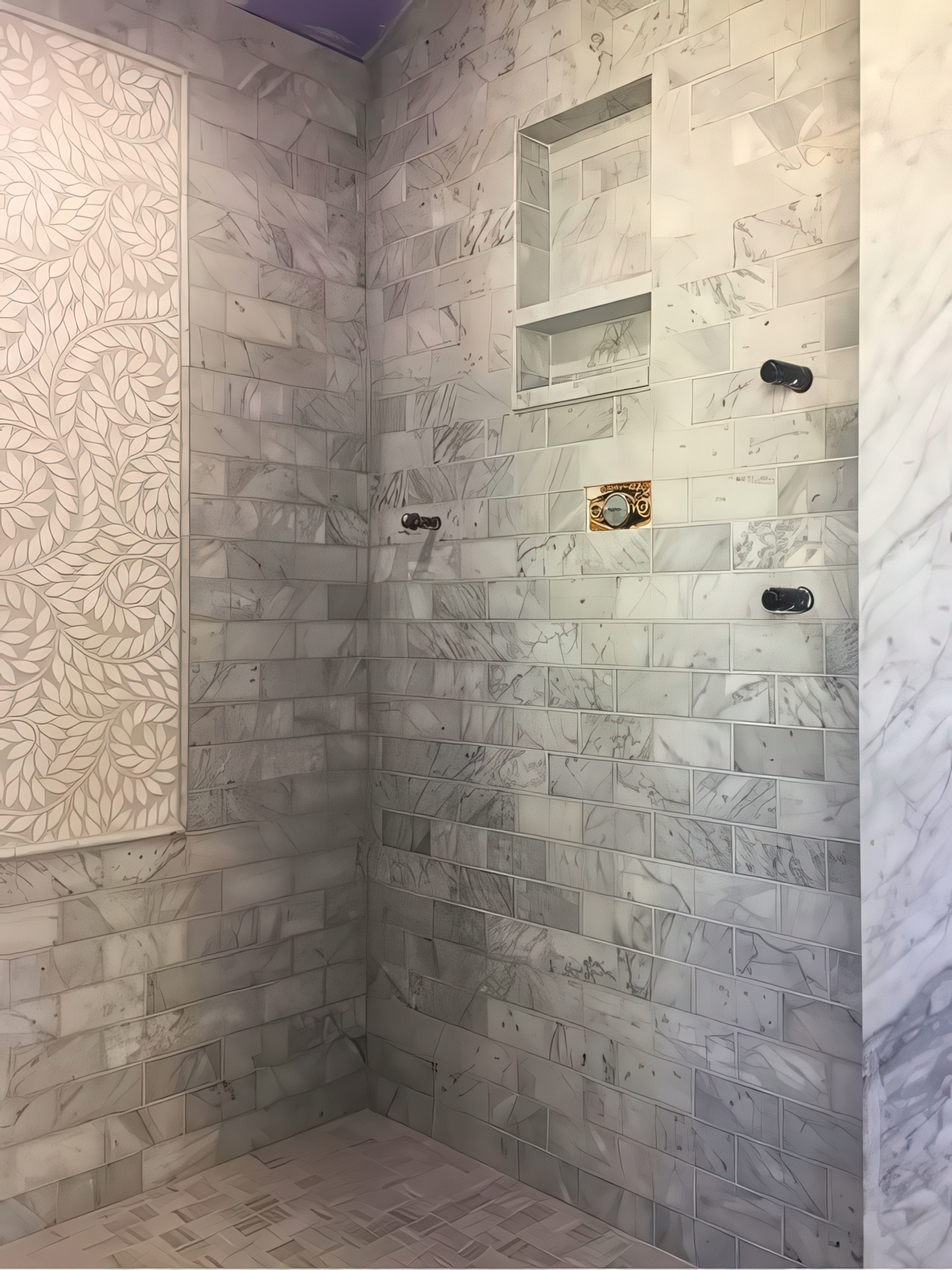 Marble shower corner with recessed storage niche and leaf mosaic accent wall