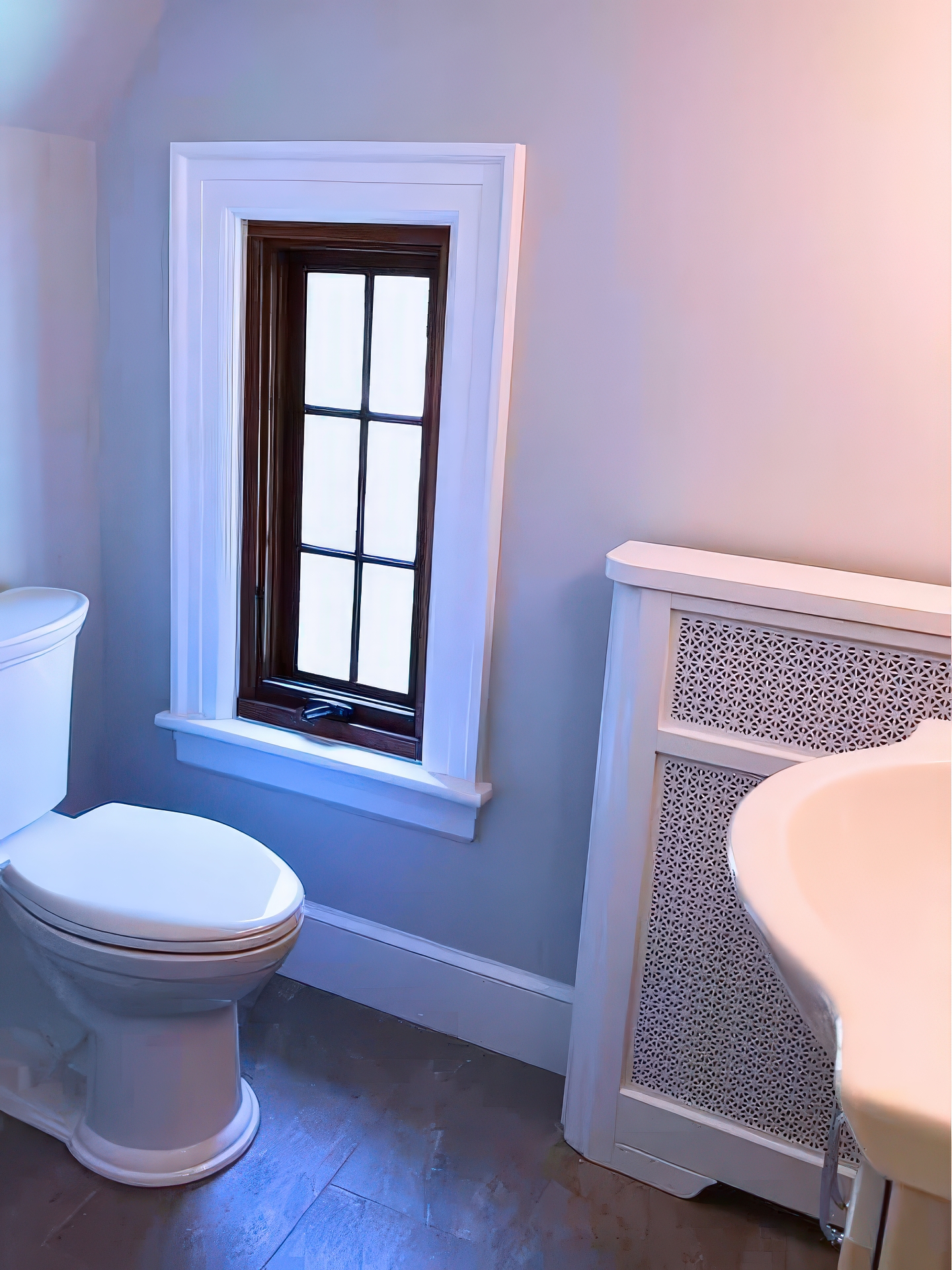 Toilet area with dark-framed window, white trim, radiator cover, and gray floor tile