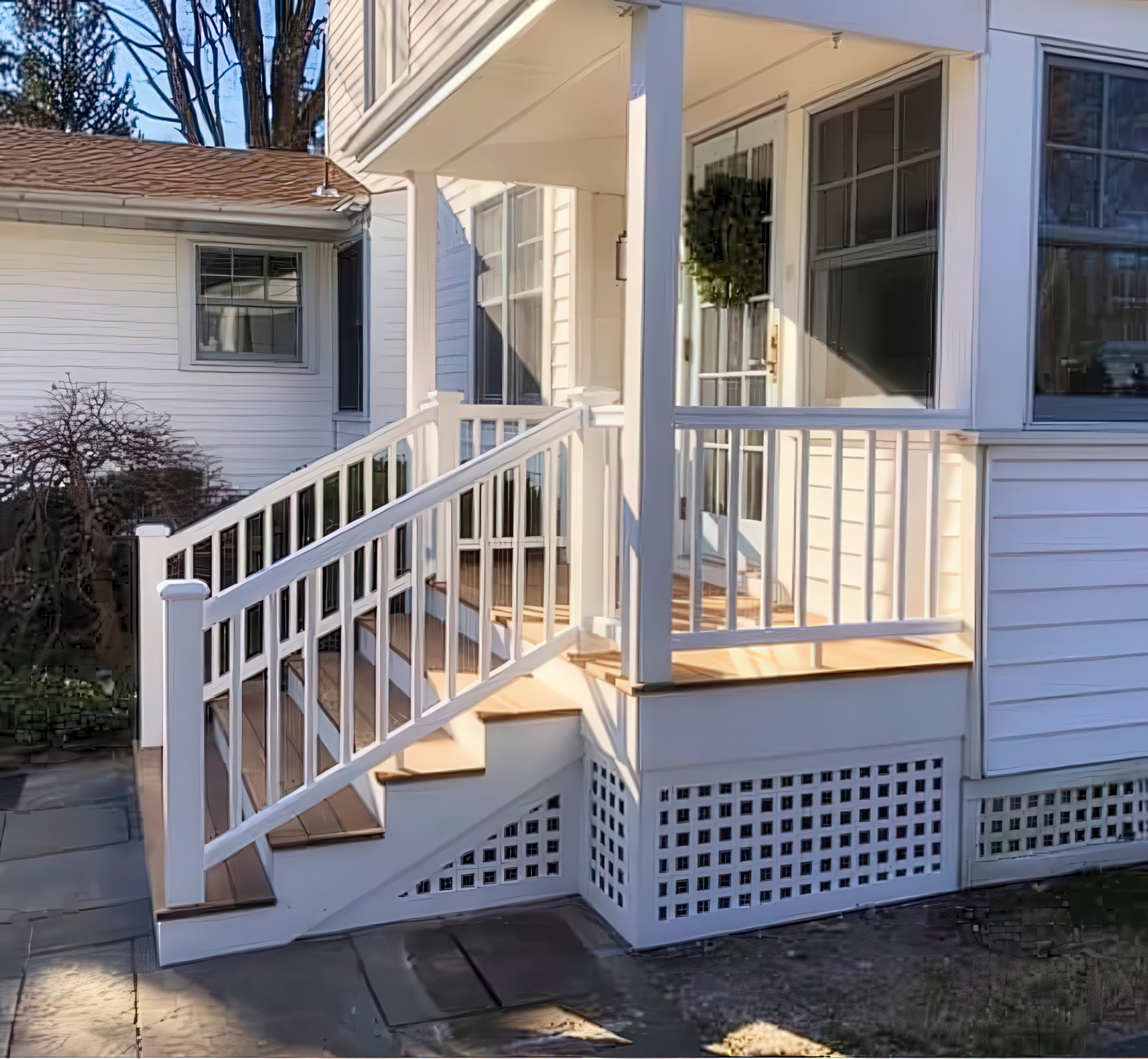 Corner angle showing deck depth, lattice panels, and bluestone walkway