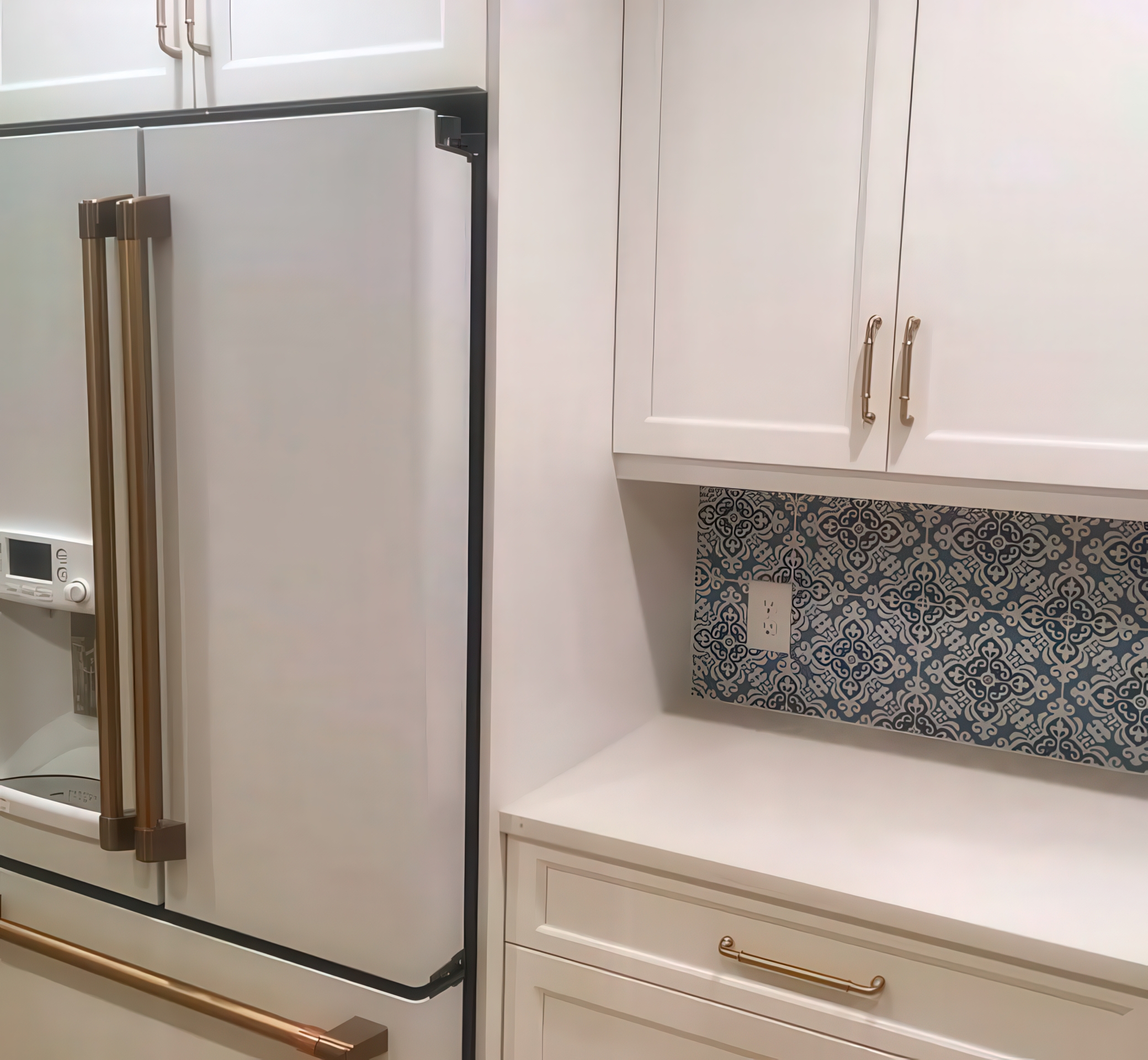 French door refrigerator with white cabinetry and tile backsplash